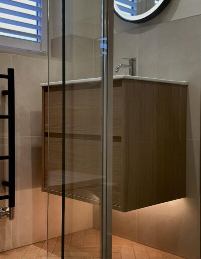 Floating wood vanity unit with modern walk-in shower in Derby bathroom design